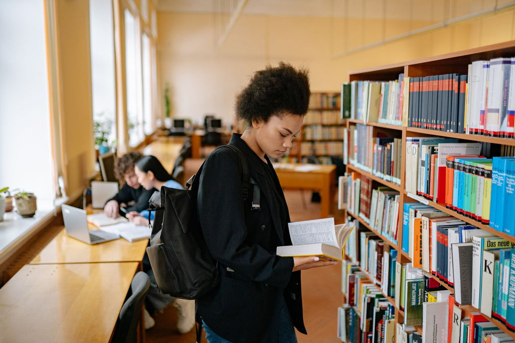 Students studying in a university library (photo via Pexels)